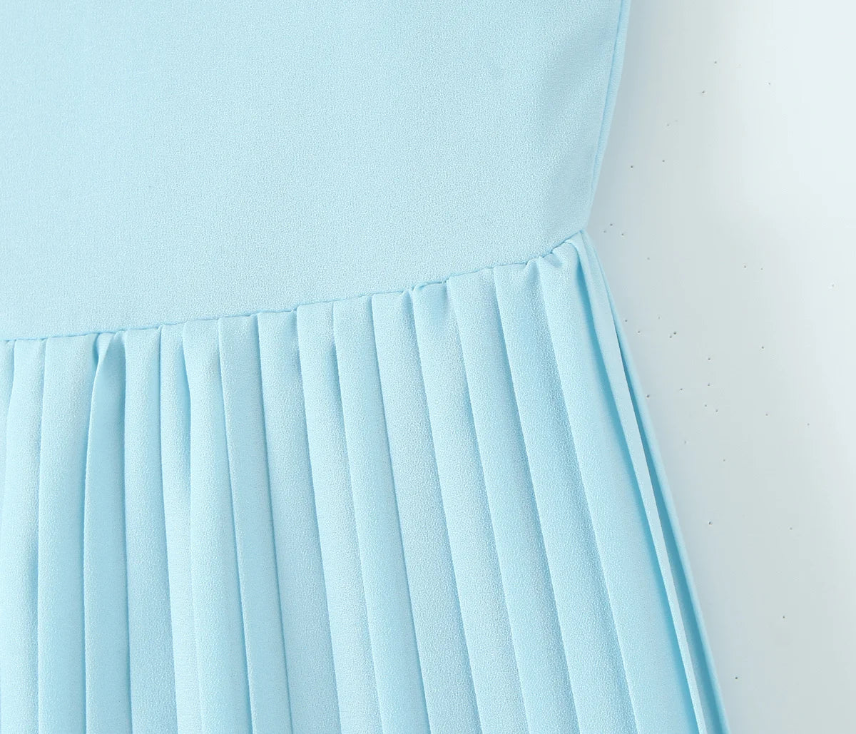 one-shoulder dress with pleated skirt